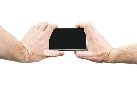 Male hands holding smartphone for photographing, isolated on white background, first person viewの写真素材