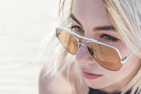 Portrait of a woman in sunglasses, close-up, blurred background, top viewの写真素材