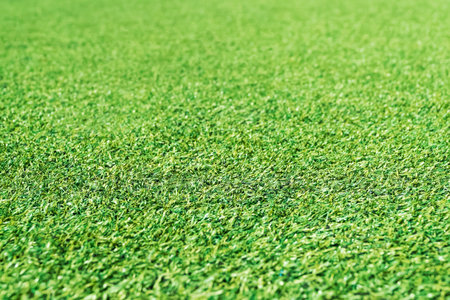 Artificial green grass, perspective, stretching into the distance