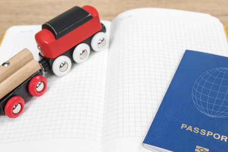 Concept planning an overseas trip by train with a toy train, a passport and diaryの写真素材
