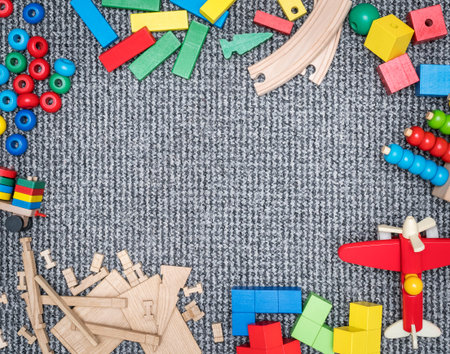 children carpet with a frame made of wooden toys on the edges