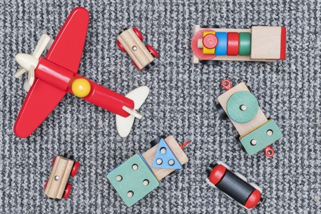 children wooden toys model trains and aircraft on the carpetの写真素材