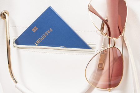 glasses and a passport in the pocket of a woman bag as a concept of a trip to the seaの写真素材