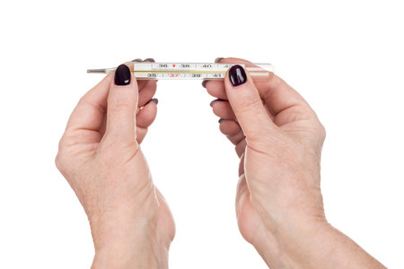 female senile hands hold a thermometer, shows high temperature, isolated on white background
