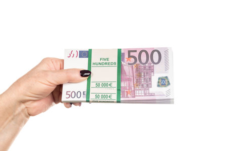 bundle of money nominal value of five hundred euro in a female hand with manicure, isolated on a...