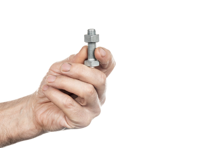 Bolt and nut in male workers hands isolated on white backgroundの写真素材