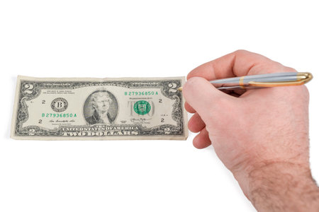 male hand draws on old dollars with pen isolated on white background