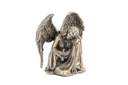 bronze statuette of a sitting girl - an angel with a bird in her hand, isolated on white backgroundの写真素材