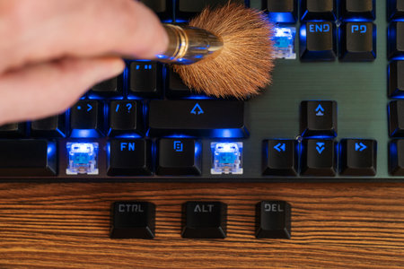 control alt and delete keys lie next to the keyboard, which is cleaned with a brush from dust