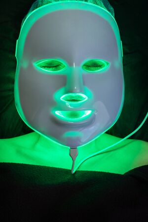 cosmetic mask of light therapy on the patient face, burning greenの写真素材