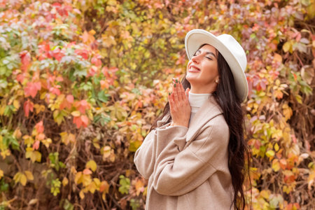 A beautiful woman enjoying the fall weatherの写真素材