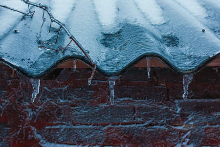 The winter ice rooftop icicles Frost snowの写真素材