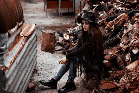 Beautiful young woman in white hat sitting on wooden autumn reverie, daydreamingの写真素材