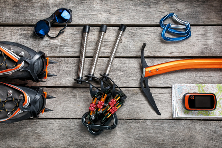 Top view of tourist equipment for a mountain trip on a rustic light wooden floor.の写真素材
