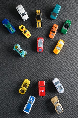 Colorful automotive toys. The apartment was lying, on a gray backgroundの写真素材