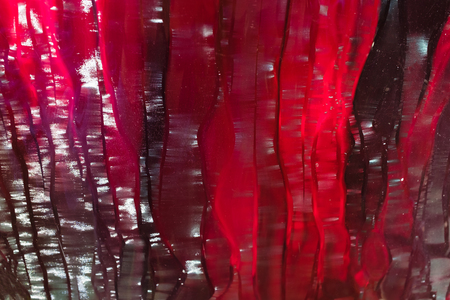 Red ruby glass Textured background, with a green tintの写真素材