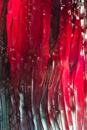 Red ruby glass Textured background, with a green tintの写真素材