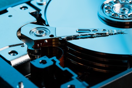 Disassembled hard drive from the computer, hdd with mirror effect. Opened hard drive from the computer hdd with mirror effects. Part of computer pc, laptop.の写真素材