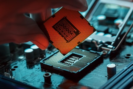 Electronic engineer of computer technology. Maintenance computer cpu hardware upgrade of motherboard component. Pc repair, technician and industry support concept.の写真素材