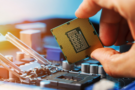 Electronic engineer of computer technology. Maintenance computer cpu hardware upgrade of motherboard component. Pc repair, technician and industry support concept.の写真素材