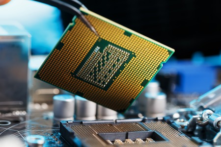 Electronic engineer of computer technology. Maintenance computer cpu hardware upgrade of motherboard component. Pc repair, technician and industry support concept.の写真素材
