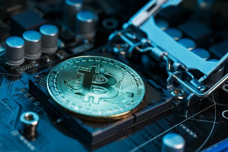 Golden Bitcoin Cryptocurrency on a computer board. Macro shooting. The concept of cryptocurrency with coins, bitcoin on a computer processor. New cryptocurrency, three coins Bitcoin and computer duties.の写真素材