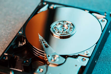 Disassembled hard drive from the computer, hdd with mirror effect. Opened hard drive from the computer hdd with mirror effects. Part of computer pc, laptop.の写真素材
