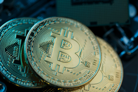 Golden Bitcoin Cryptocurrency on a computer board. Macro shooting. The concept of cryptocurrency with coins, bitcoin on a computer processor. New cryptocurrency, three coins Bitcoin and computer duties.の写真素材