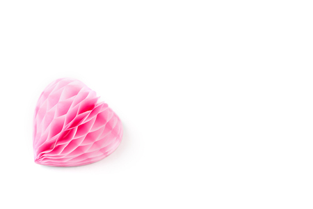 A lush pink paper heart on a white background. Paper heart isolated on whiteの写真素材