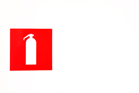 Red fire extinguisher poster on light background. Fire extinguisher sign stickers on white light wallの写真素材
