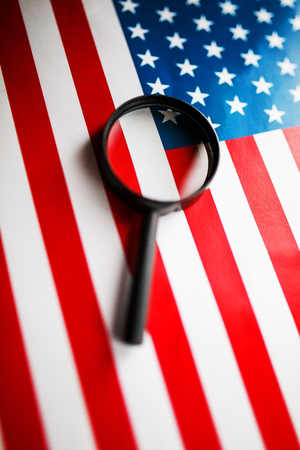 US flag looking through a magnifying glass. Study of the history and culture of the country of the United States. The concept of studying geography, English and customs.の写真素材