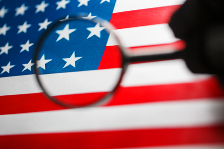 US flag looking through a magnifying glass. Study of the history and culture of the country of the United States. The concept of studying geography, English and customs.の写真素材