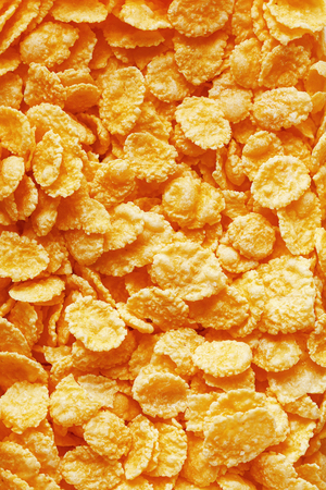 Golden cornflakes background and texture. View from above. cornflakes healthy breakfast. Close-upの写真素材