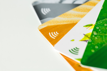 Credit cards with contactless payment. Pile of credit cards on white isolated background. Selective focus and close-up.の写真素材