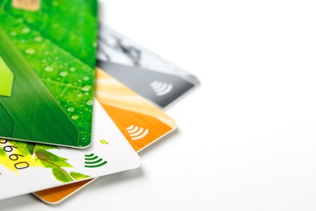 Credit cards with contactless payment. Pile of credit cards on white isolated background. Selective focus and close-up.の写真素材