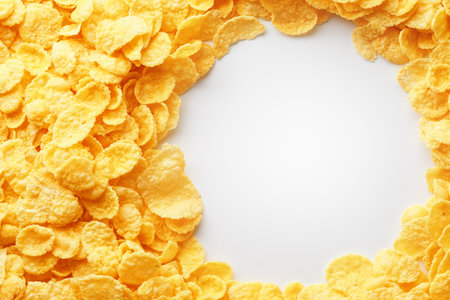 Golden Cornflakes full frame with empty round copy space in the middle as viewed from above. View...