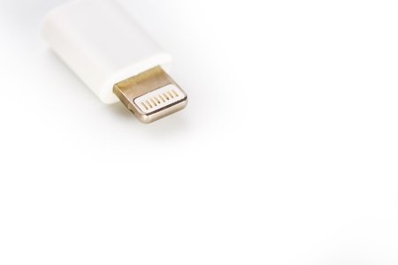 Connector lightning on a white background. This is a proprietary connector used to connect mobile...