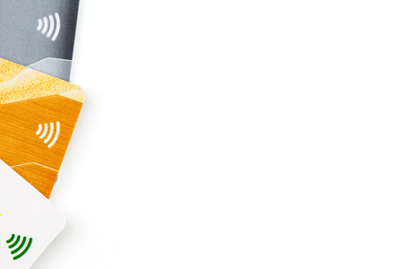 Credit cards with contactless payment. Pile of credit cards on white isolated background. Selective focus and close-up.の写真素材