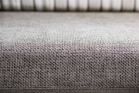 Closeup of a fragment of a beige textile sofa in the room. Texture of expensive fabric on furniture. Sofa element couch couch room furnitureの写真素材