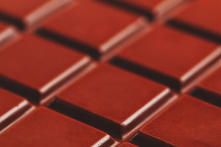 Texture of dark chocolate close up. Segments of a chocolate bar in macro. Full frame texture. Macroの写真素材