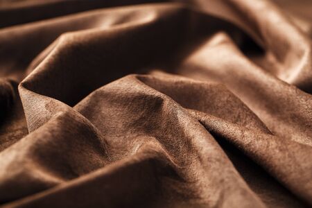 Brown velor textural background pattern. Gorgeous elastic velor fabric has a velvet pile, shine and texture. Volumetric background of velor fabric.の写真素材