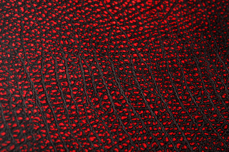 Red - black textured reptile skin, used texture for the background. Lizard or crocodile skin....