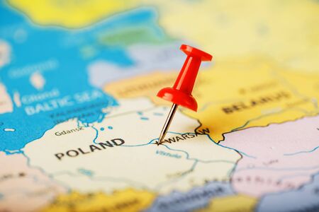 The location of the destination on the map Poland is indicated by a red pushpin. Poland is marked on the map with a red buttonの写真素材
