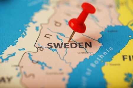 The location of the destination on the map Sweden is indicated by a red pushpin. Sweden is marked on the map with a red buttonの写真素材