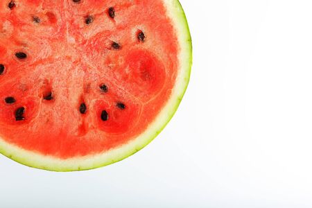 Half slices of tasty and ripe red watermelon on a white background, isolated texture of juicy pulp of ripe red watermelon with seedsの写真素材