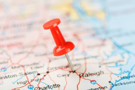 Red clerical needle on a map of USA, South North Carolina and the capital Raleigh. Close up map of South North Carolina with red tack, United States map pin USAの写真素材