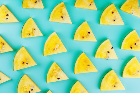 Summer pattern of yellow fruit watermelon slices on a light blue background. Minimal summer concept....