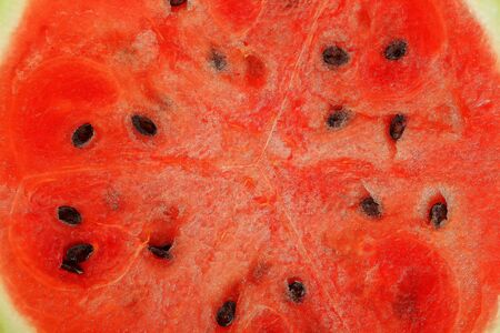 Half of juicy, red watermelon on a white background, texture of juicy pulp and mesmeses of ripe watermelon, closeupの写真素材