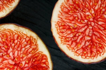 Figs are ripe. Closeup of sliced fig fruits in the form of a texture inscribed in a rectangle on a...