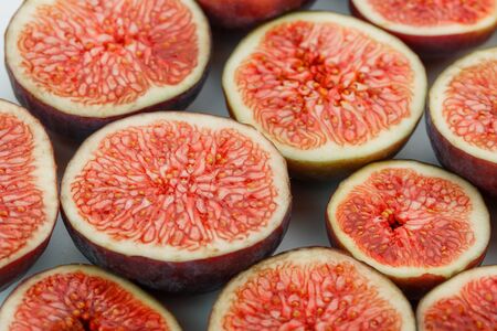 Figs are ripe. Creative diagram of chopped figs on a white background in the form of a texture inscribed in a rectangle. Top view food photoの写真素材